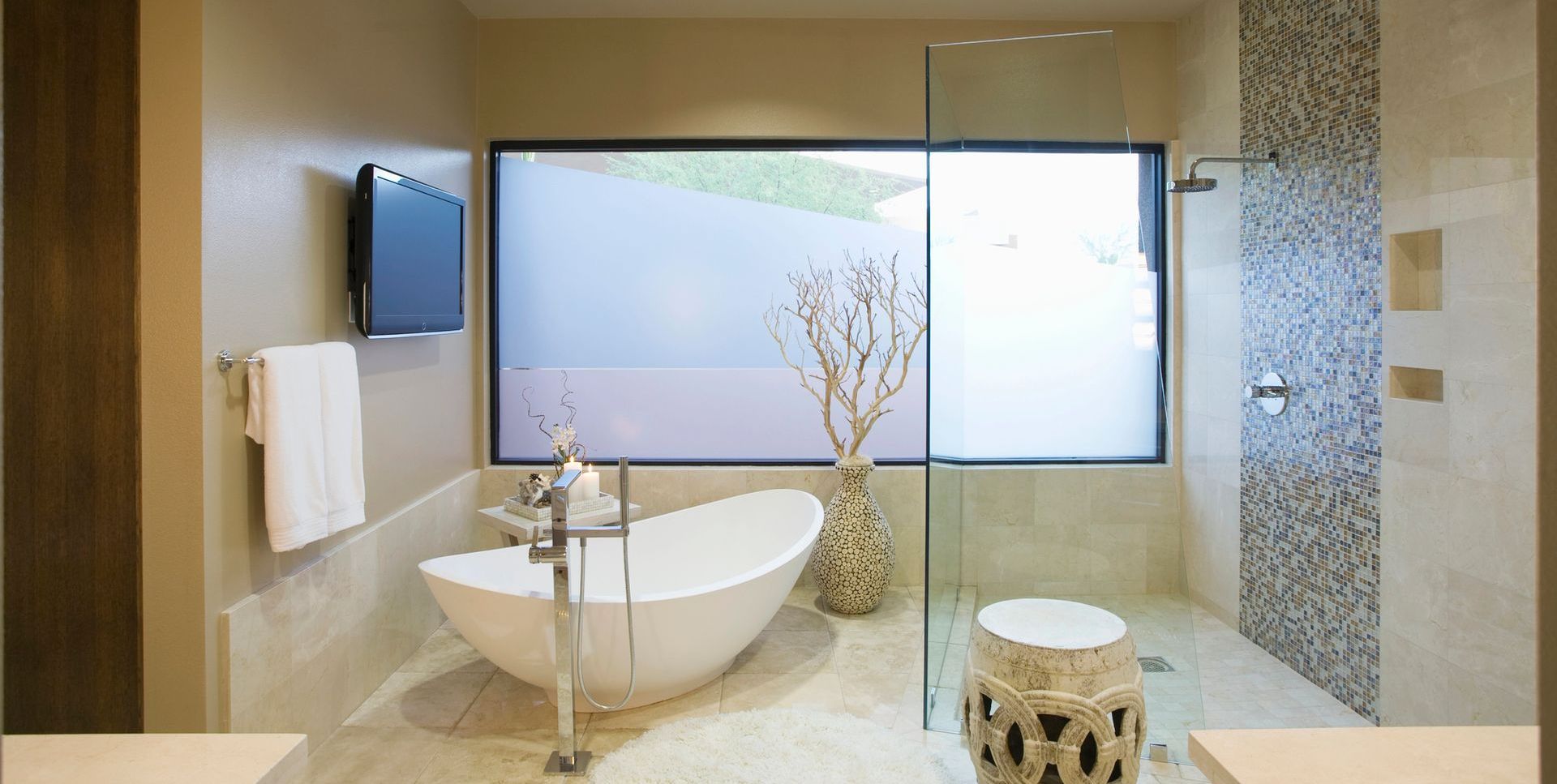 A bathroom with a bathtub and a walk in shower