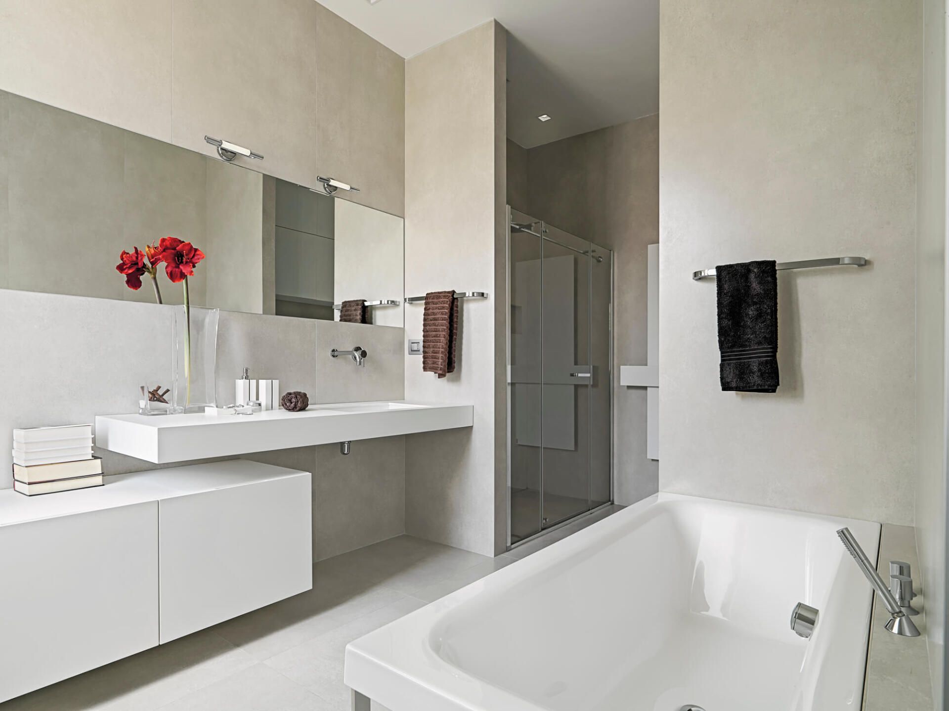 A bathroom with a bathtub , sink and mirror