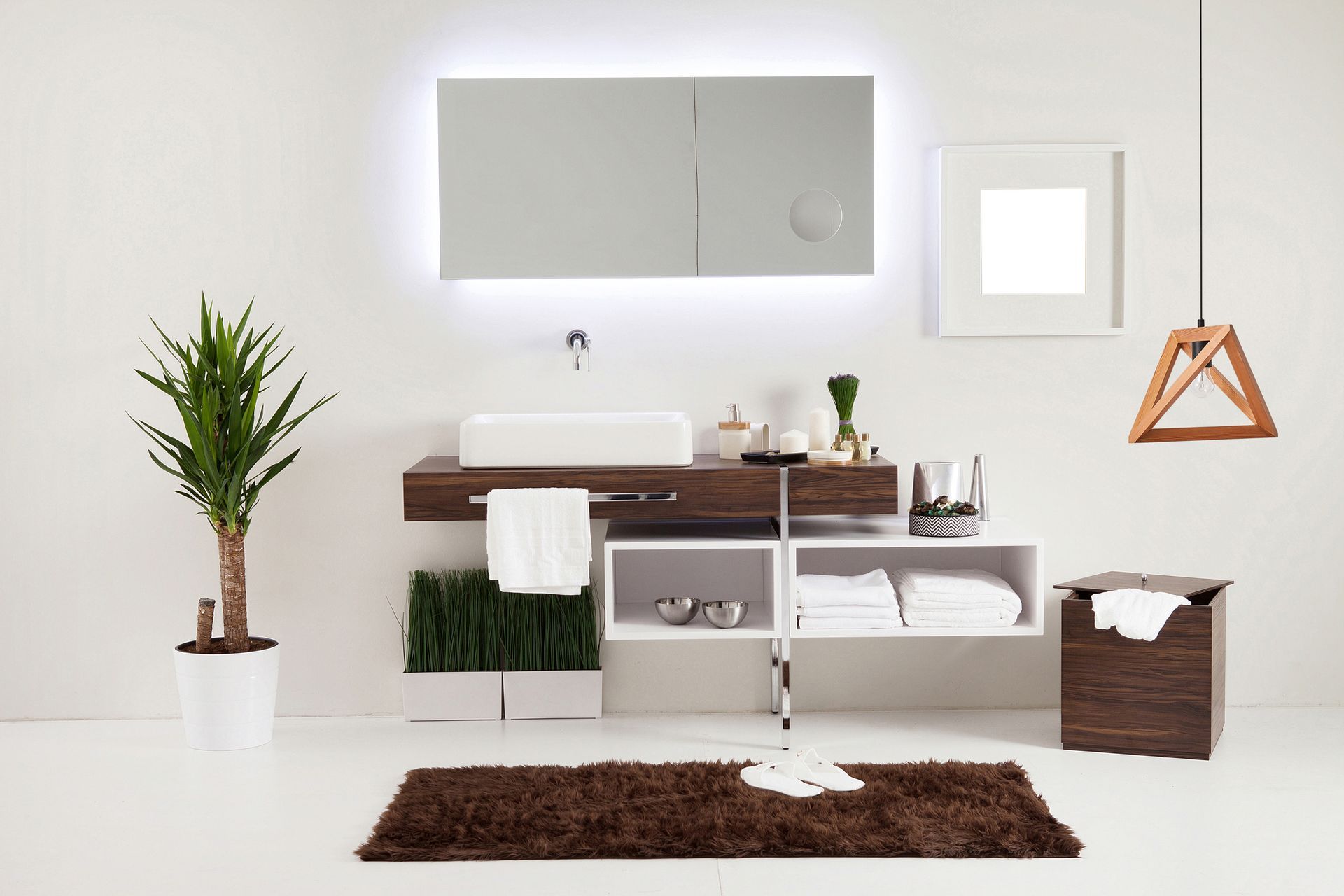 A bathroom with a sink a mirror and a plant