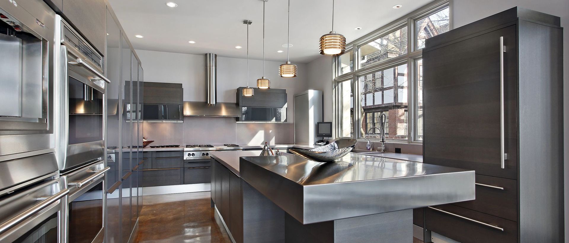 A kitchen with stainless steel appliances and a large island