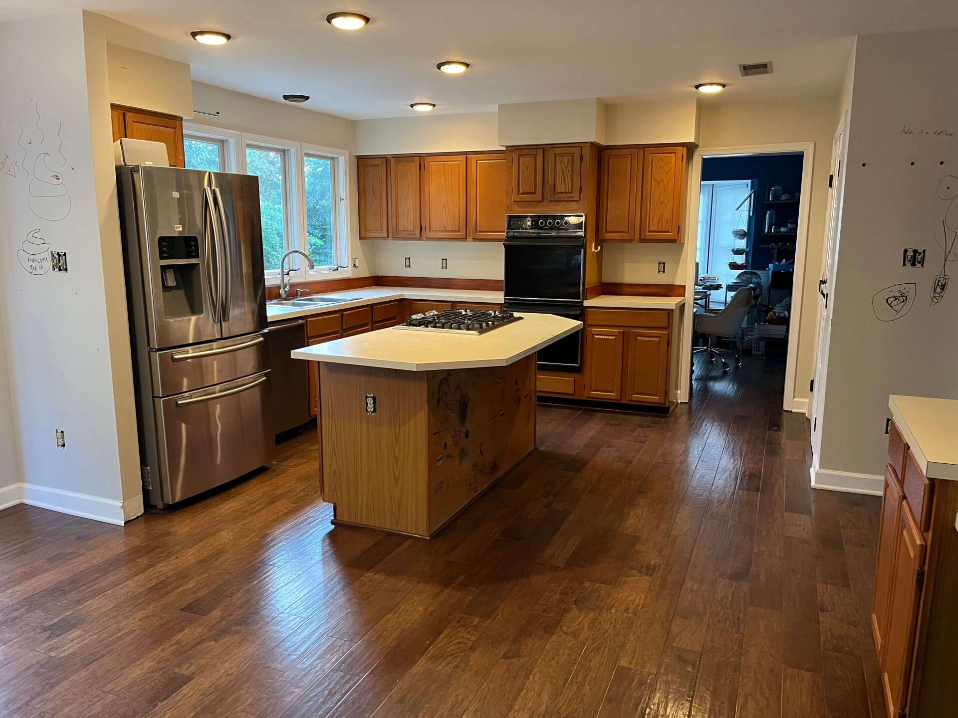 A kitchen with stainless steel appliances and wooden cabinets.