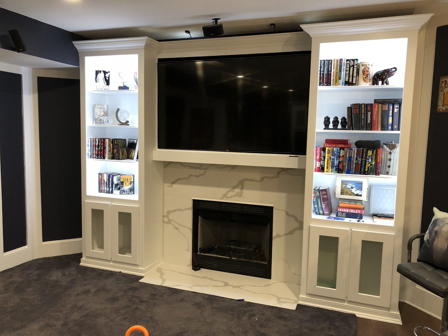 A living room with a fireplace and a flat screen tv
