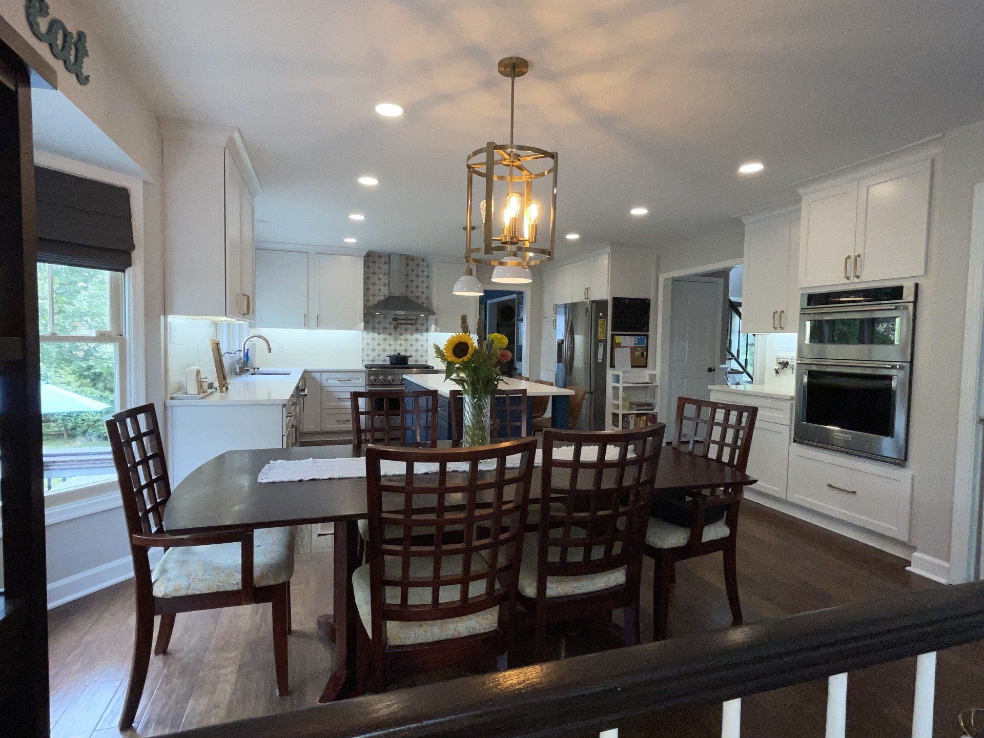 A kitchen with a table and chairs and a sign that says eat