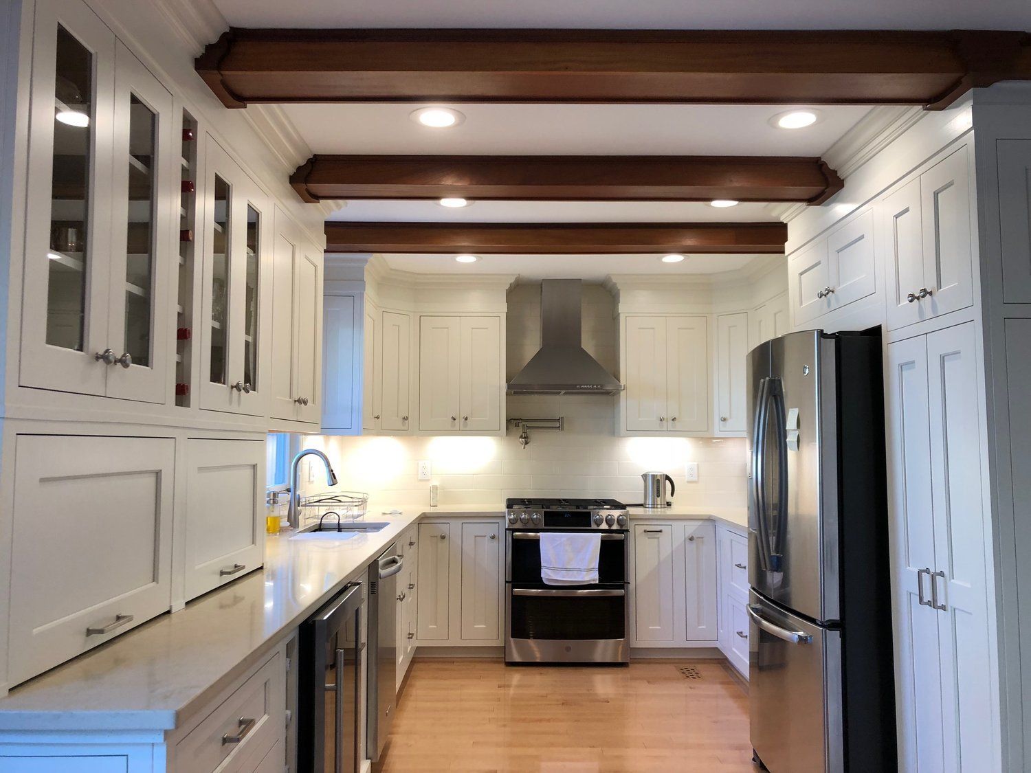 A kitchen with white cabinets and stainless steel appliances