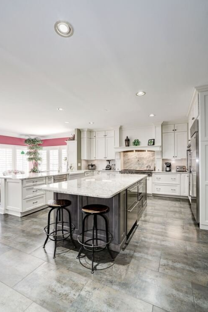 A large kitchen with a large island and stools.