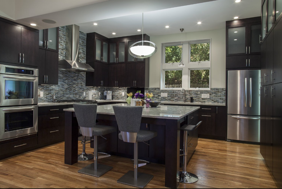 A kitchen with stainless steel appliances and a large island