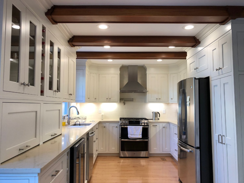 A kitchen with white cabinets and stainless steel appliances