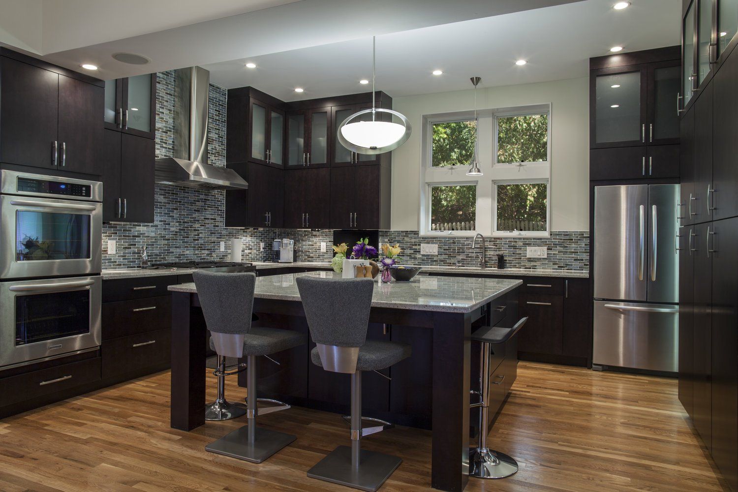 A kitchen with stainless steel appliances and a large island.