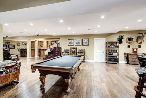 There is a pool table in the middle of the room.