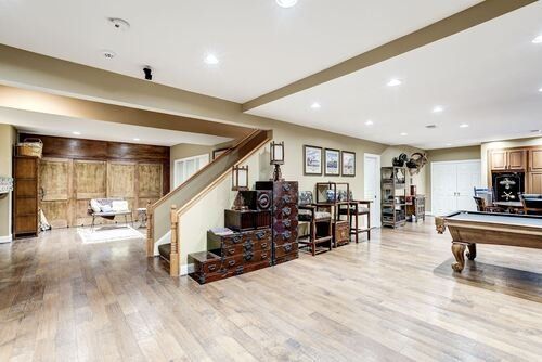 There is a pool table in the middle of the room.