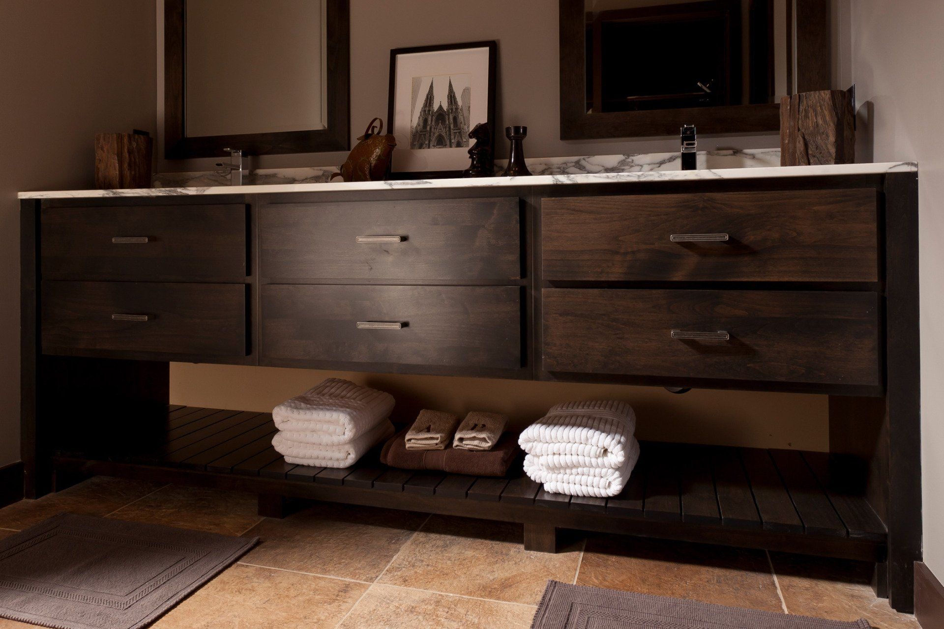 A bathroom with two sinks and a shelf with towels on it