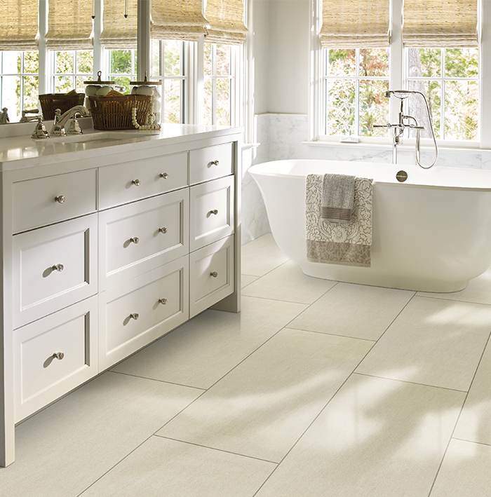 A bathroom with a tub and a dresser with drawers