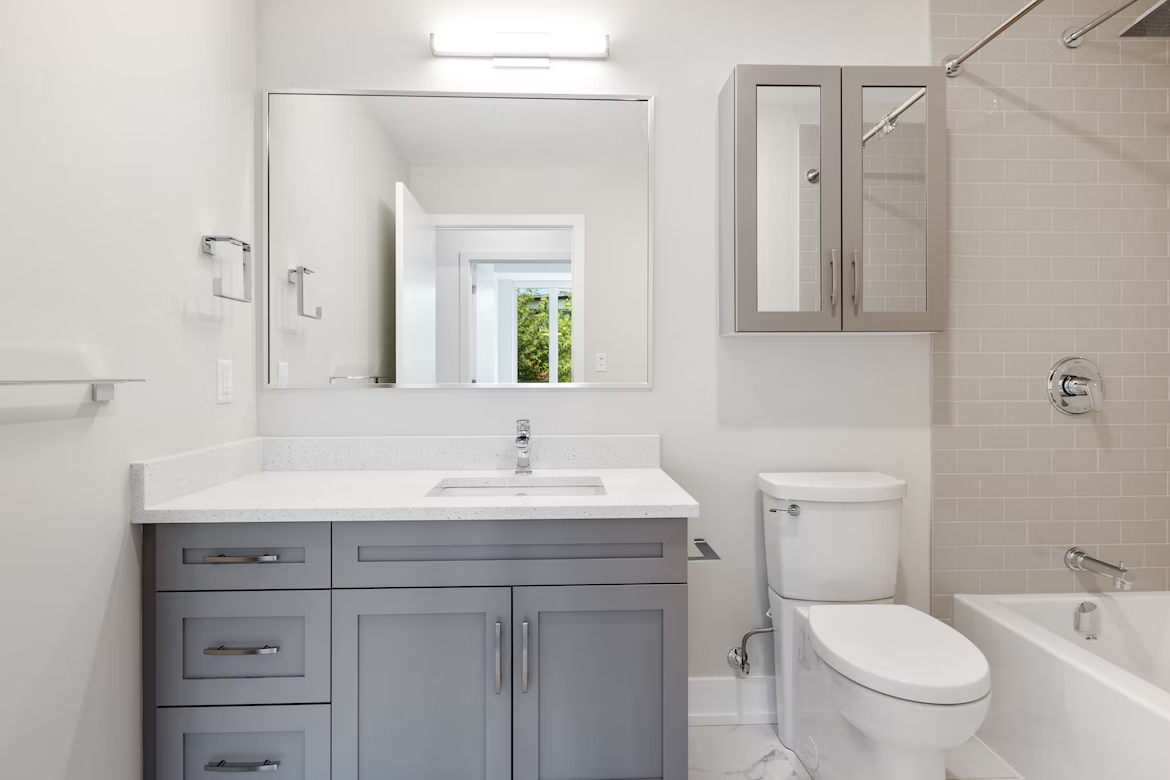 A bathroom with a sink , toilet , and bathtub.