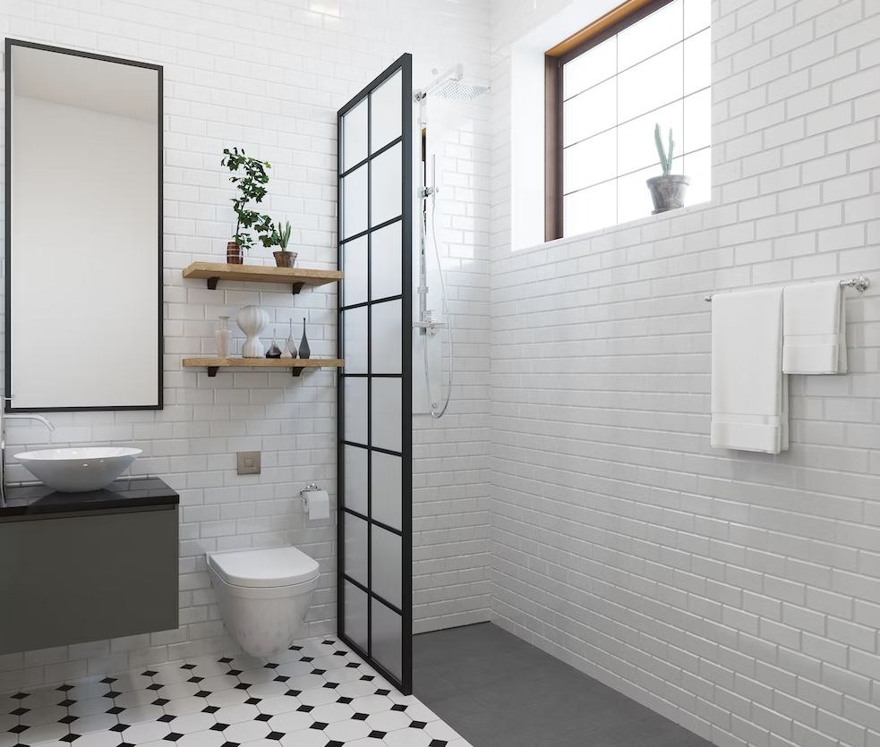 A bathroom with a toilet , sink , mirror and window.