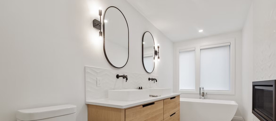 A bathroom with two sinks , a toilet , and a bathtub.