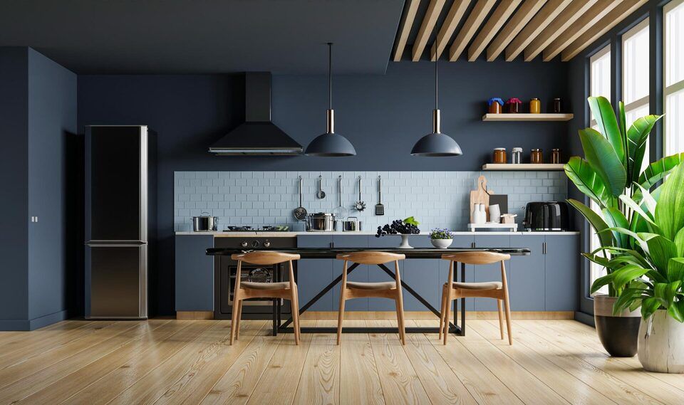 A kitchen with a table and chairs and a refrigerator.