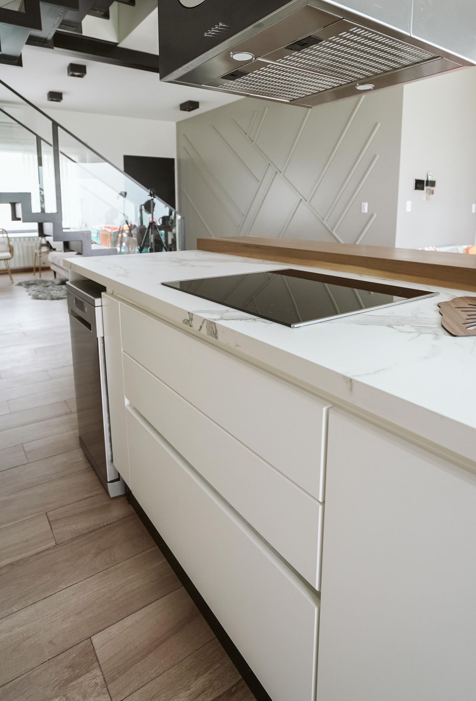 A kitchen with white cabinets and a stove top oven