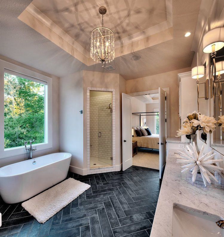A bathroom with a bathtub a sink and a window