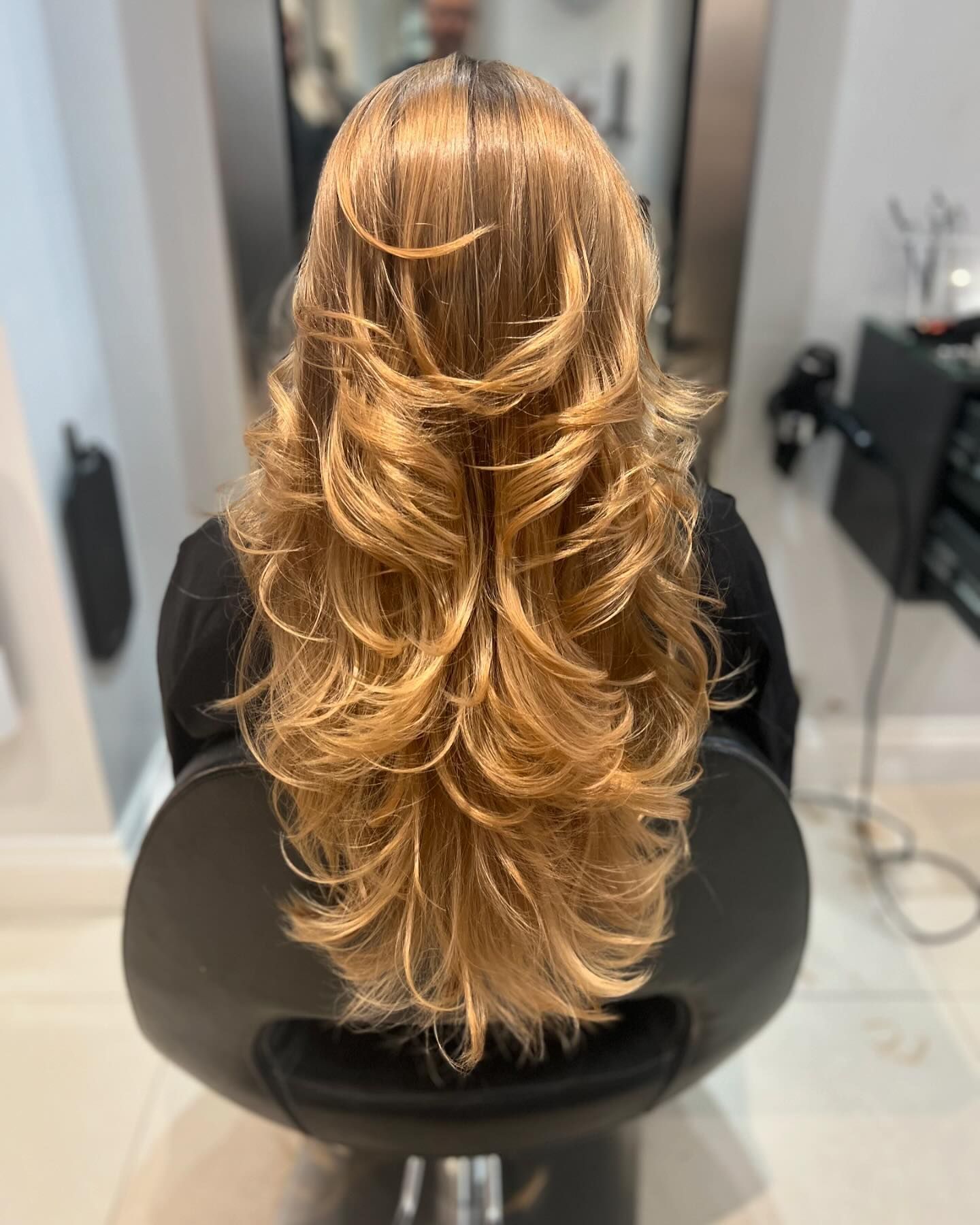 Long, layered wavy blonde-brown hair 