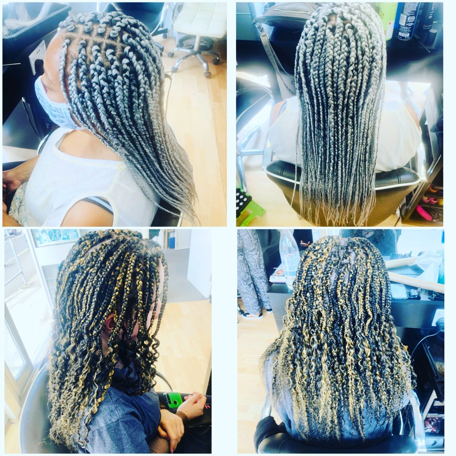 A woman is getting her hair braided in a salon.