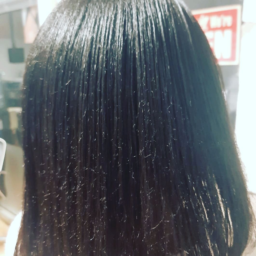 A close up of a woman 's hair with a sign in the background that says fire