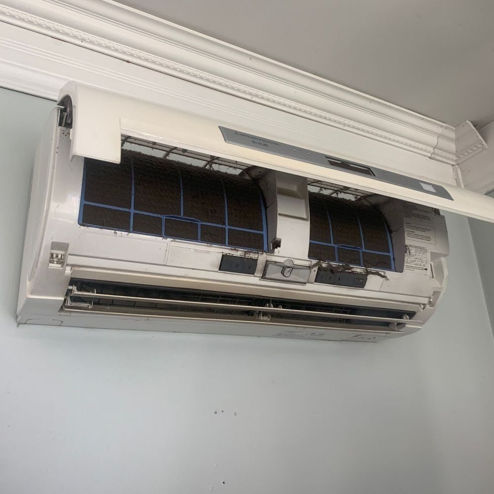 The inside of a wall mounted air conditioner with the filter removed.