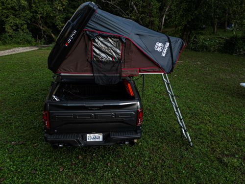 Overlanding setup featuring a bed rack and roof top tent for adventure travel.