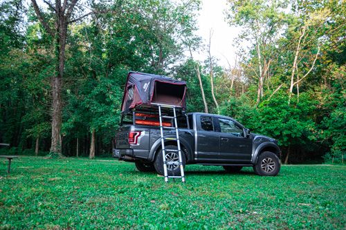 Adventure travel truck (Ford Raptor) showcasing a bed rack and roof top tent