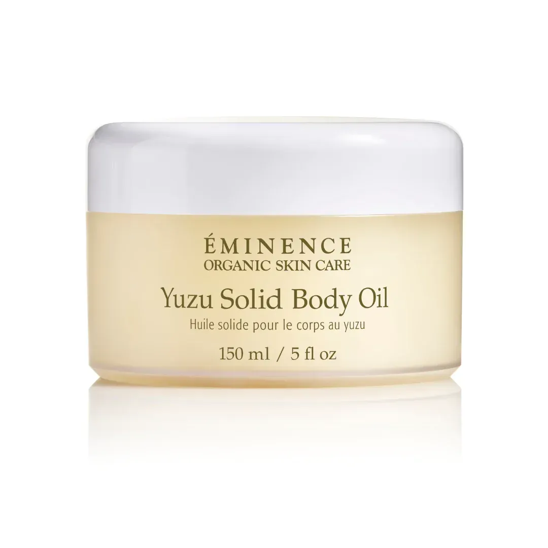 Een potje Eminence Organic Skin Care Yuzu Solid Body Oil.