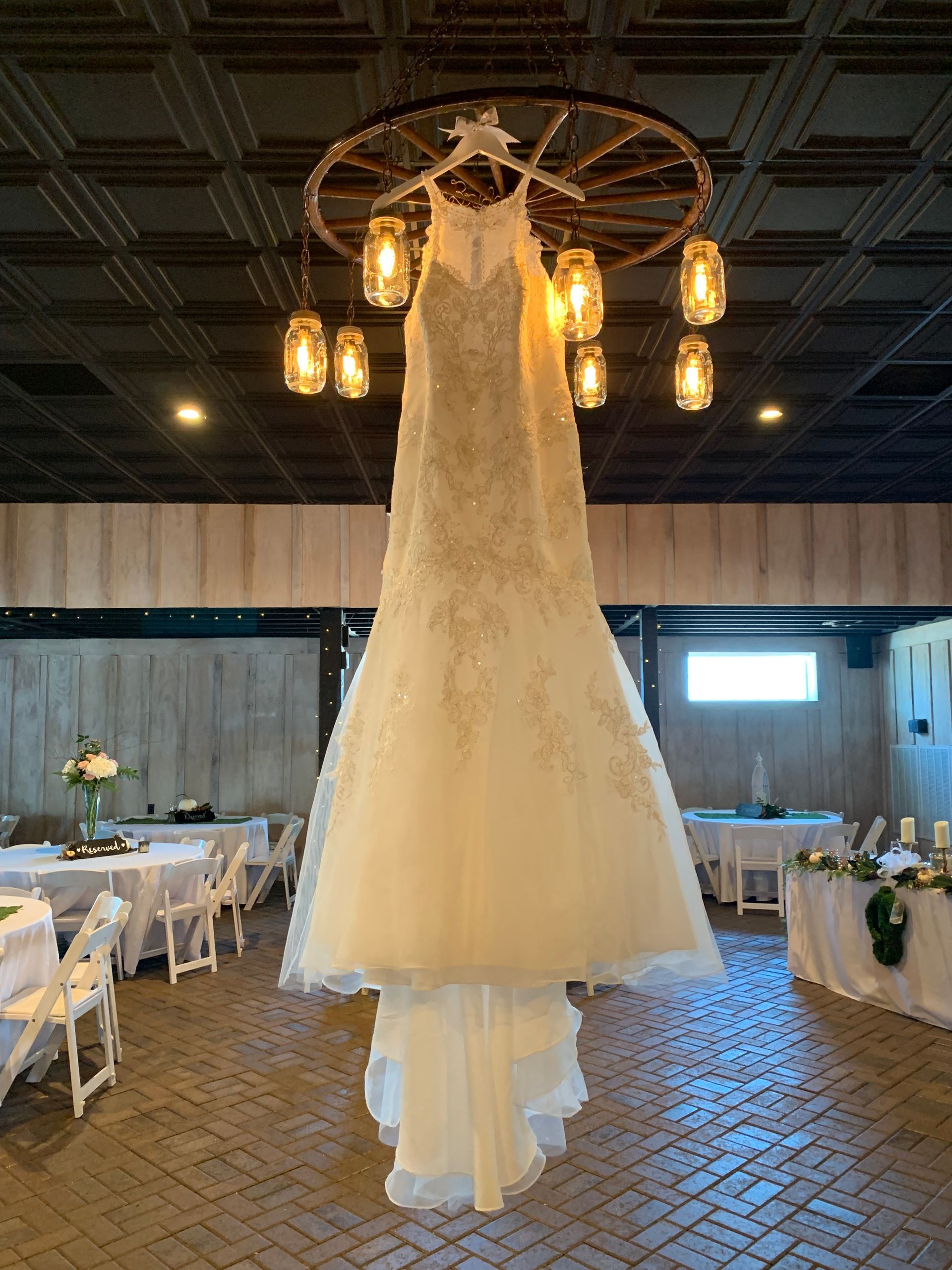 bridal gown hanging from chandelier