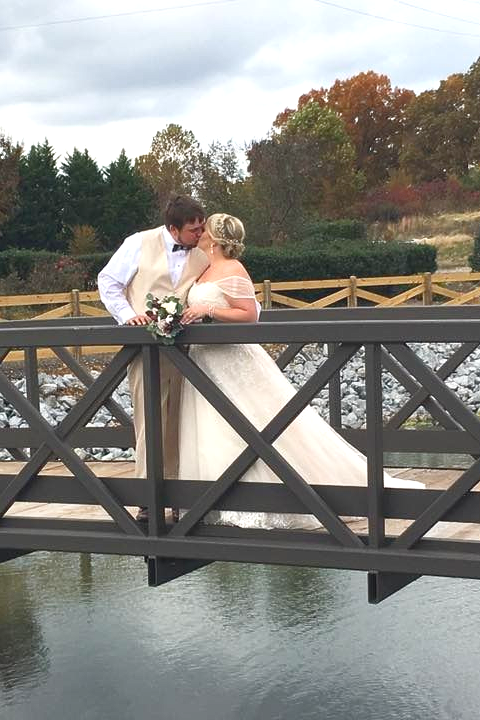 bride and groom kissing in garden