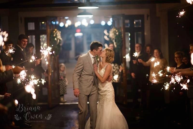 bride and groom kissing during sparkler exit