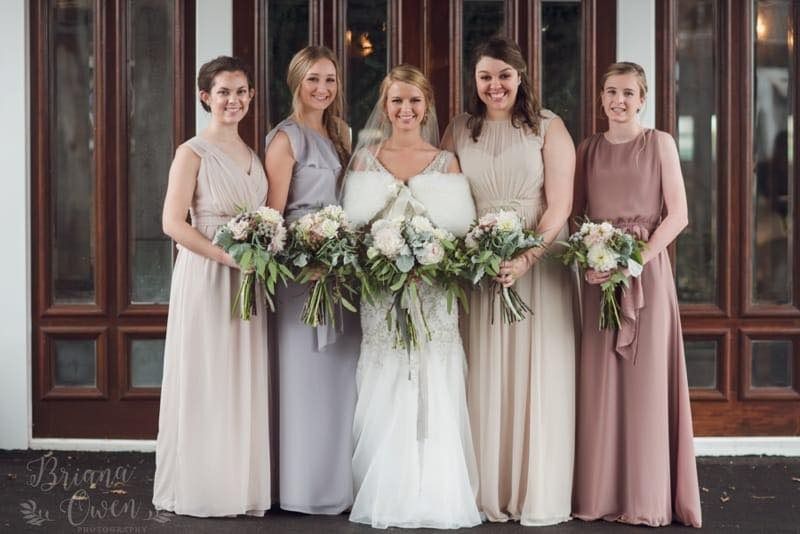 bride with bridesmaids in neutral gowns