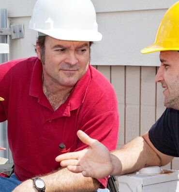 Two Workers Installing Air Conditioning