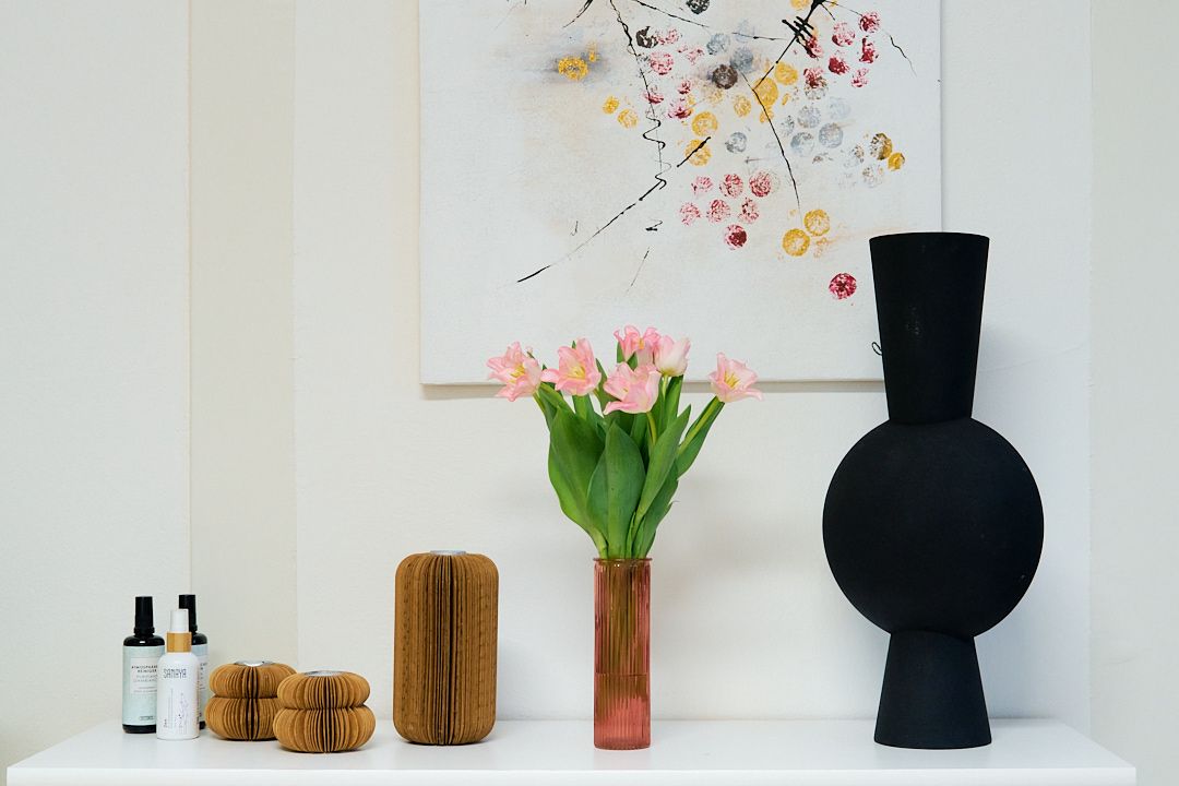 A table with a vase of flowers on it