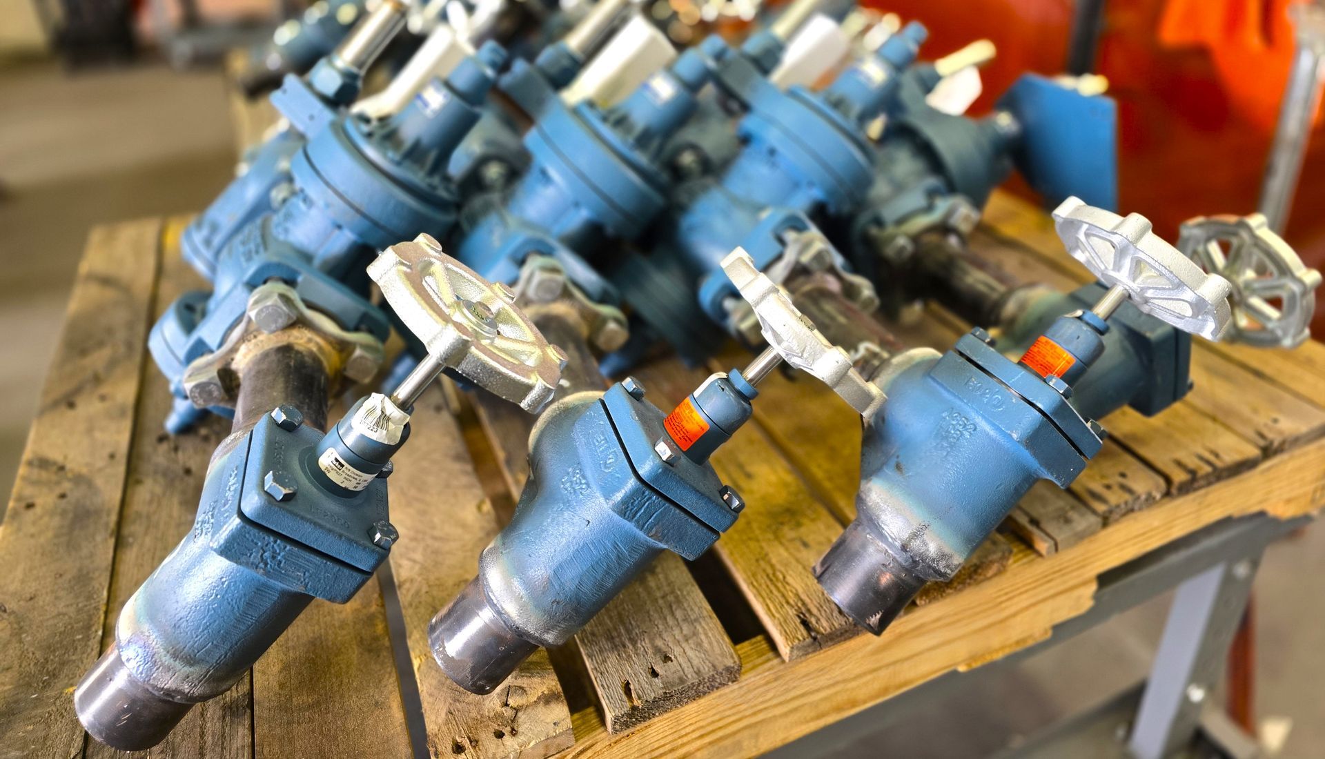 A bunch of valves are sitting on top of a wooden table.