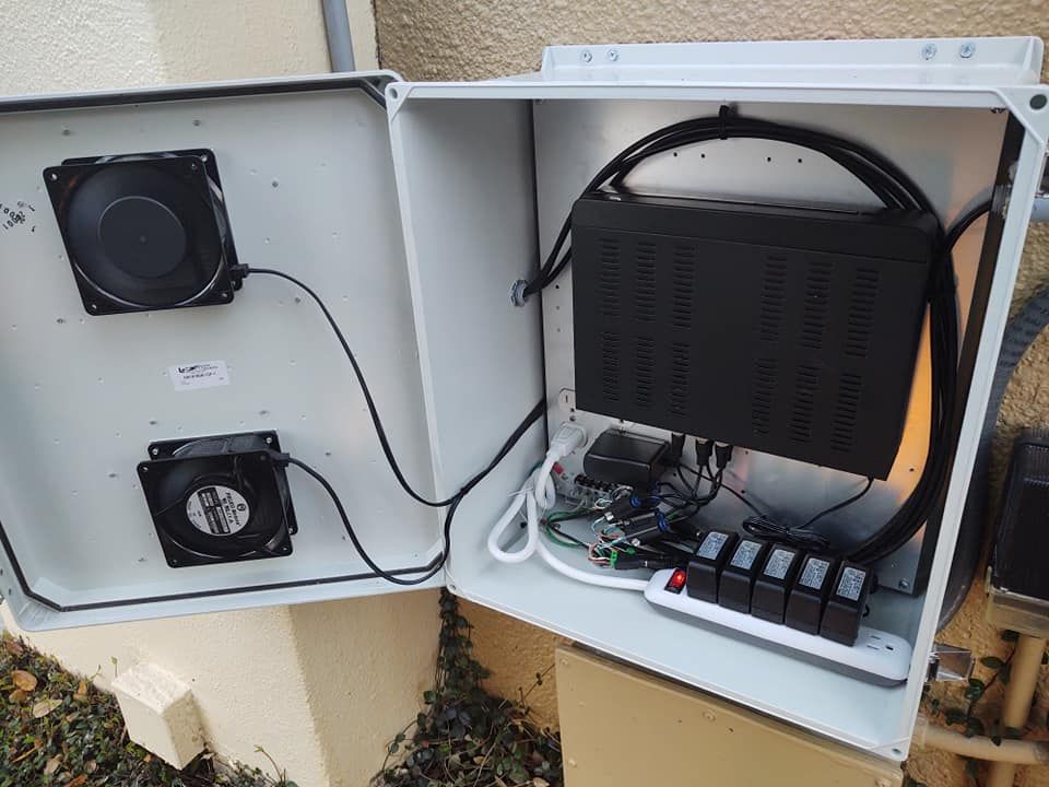 A box with a fan and a power supply inside of it.