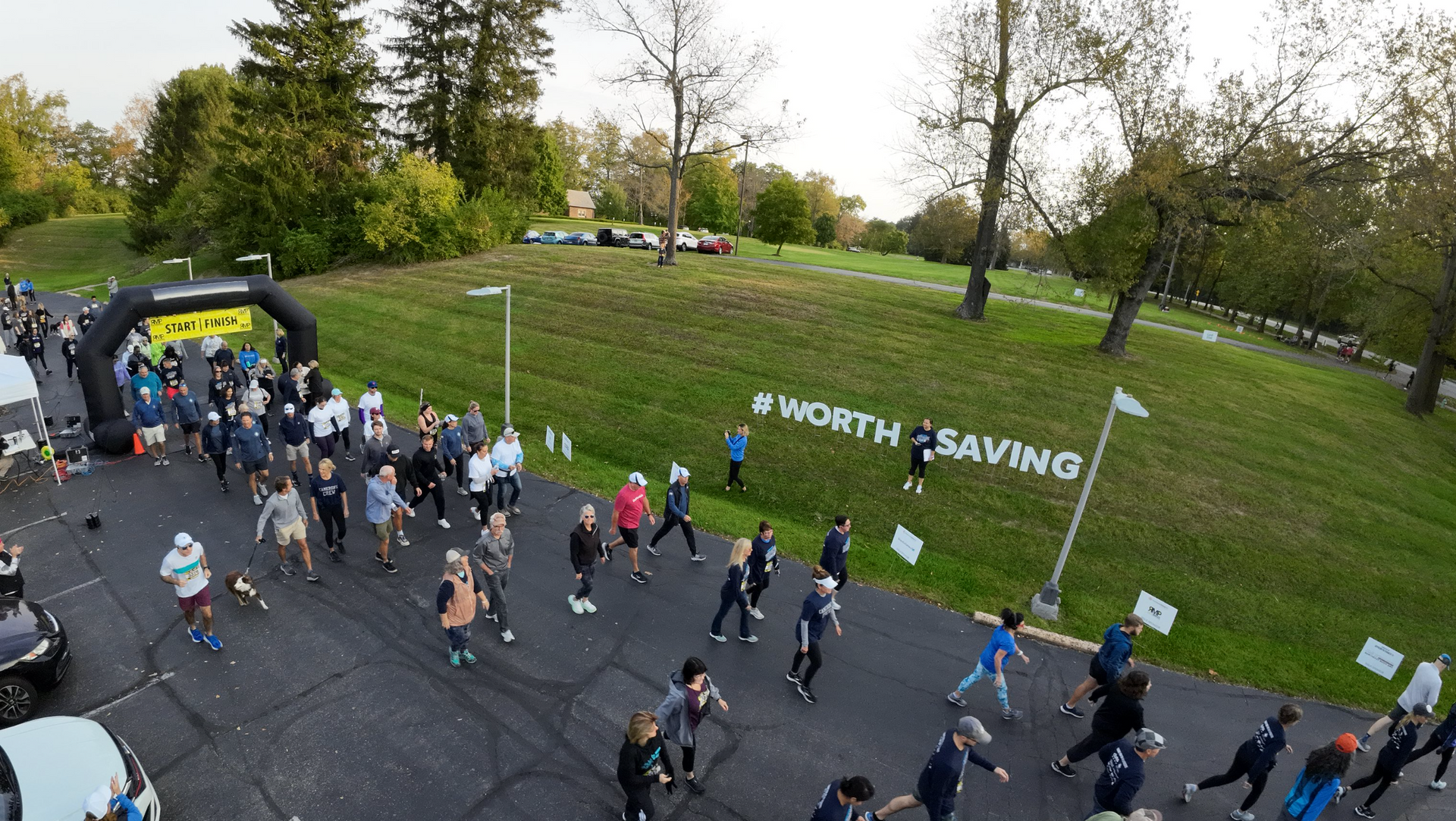 An aerial view of a group of people running in a park.