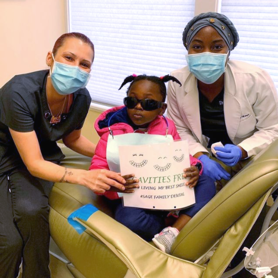 A little girl is holding a sign that says aviettes
