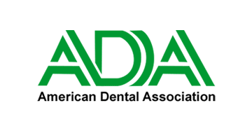 The logo for the american dental association is green and white.