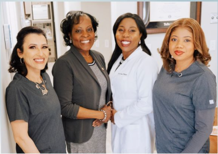 A group of women are posing for a picture together