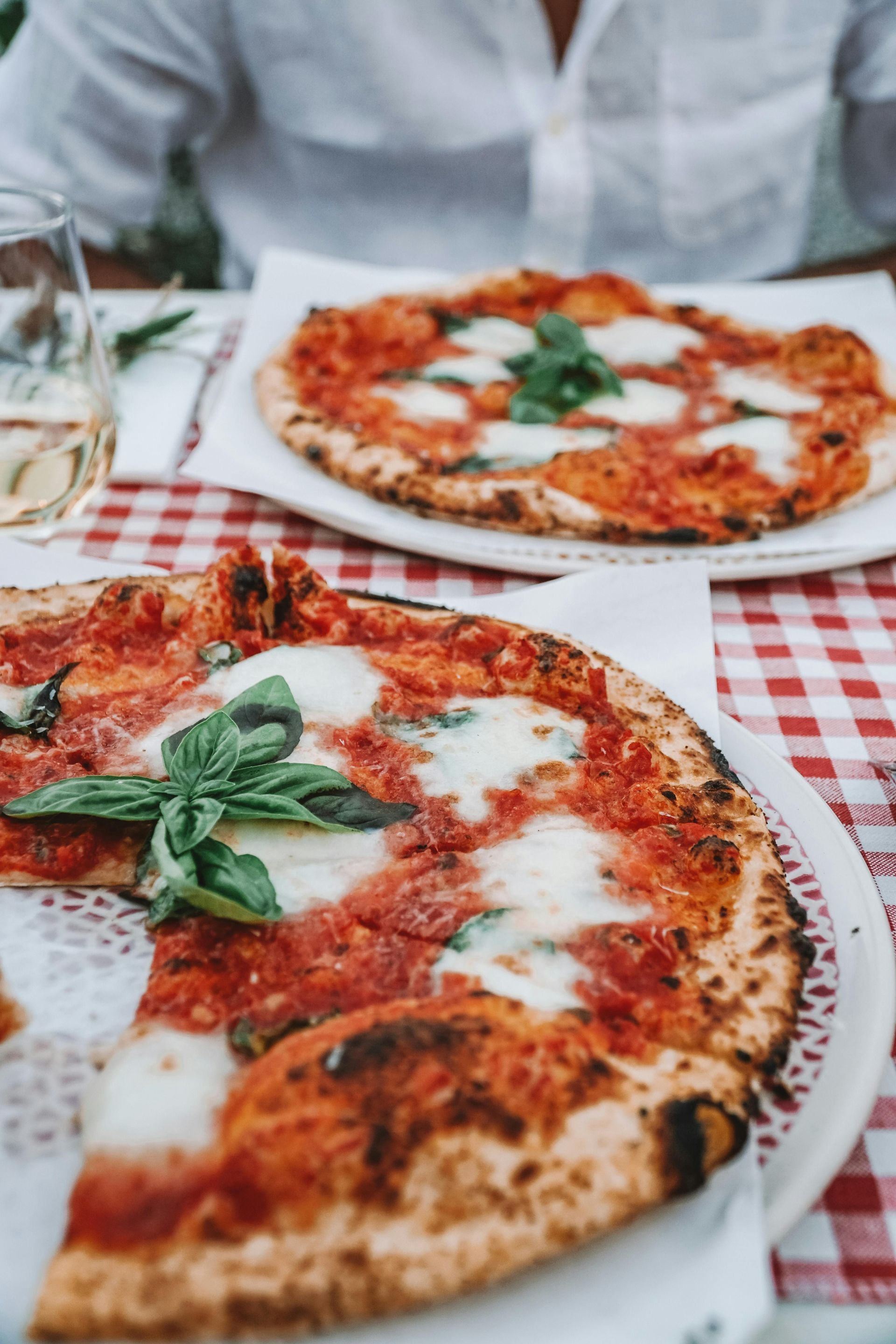 Interno accogliente di una trattoria siciliana con tavoli, luci soffuse e decorazioni autentiche.