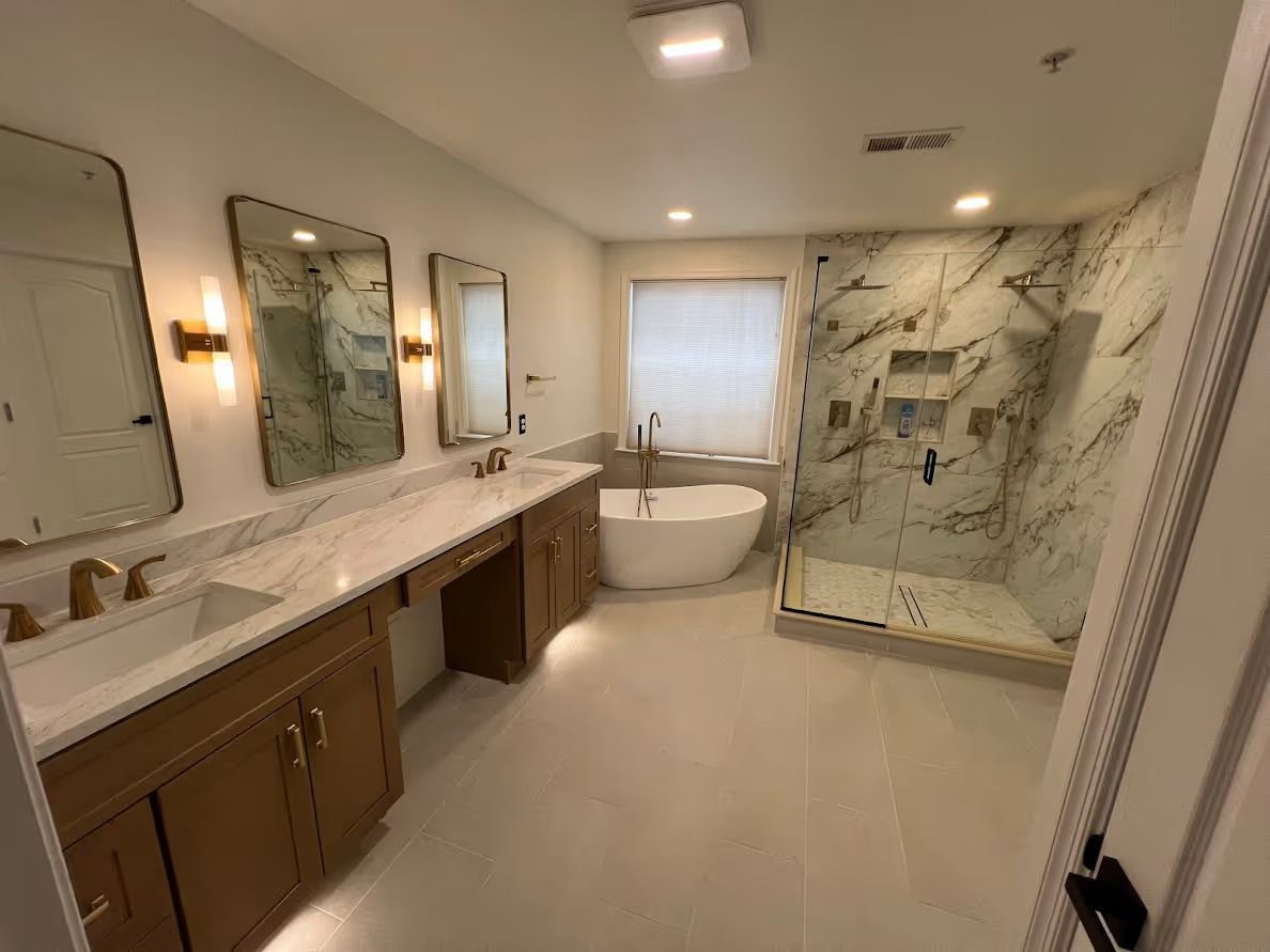 A bathroom with a tub , sinks , mirrors and a walk in shower.