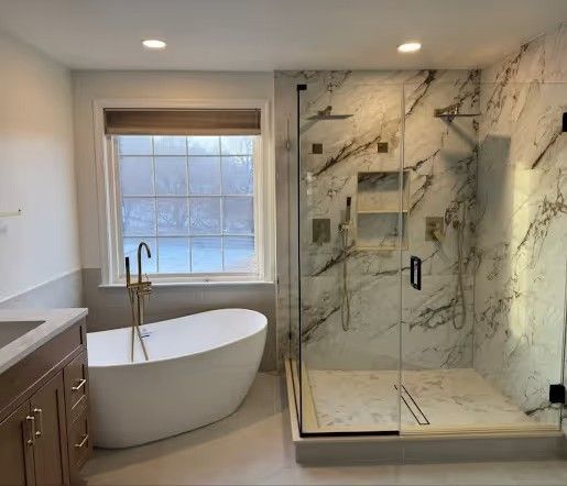 Master bathroom with freestanding tub, double vanity with center makeup area, and large two-person shower with center drain