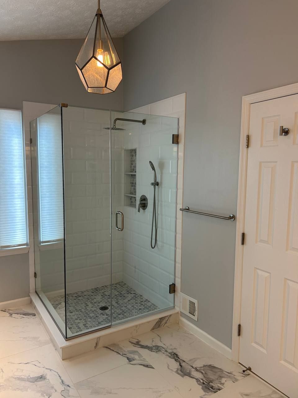 Glass-Enclosed Shower with White Subway Tile and Mosaic Floor in Finksburg Bathroom Remodel