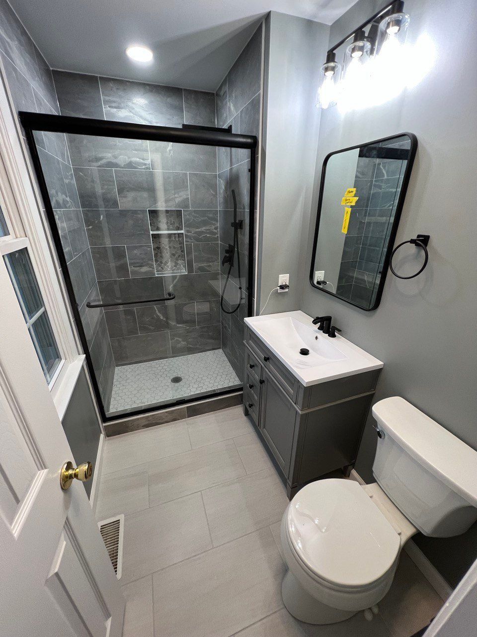 Walk-in closet converted to full bathroom in Finksburg with 48-inch shower, 30-inch vanity, and recessed shower lighting