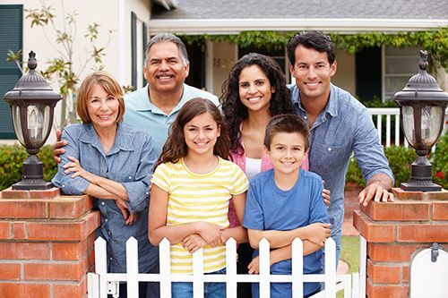 Family together in front of house