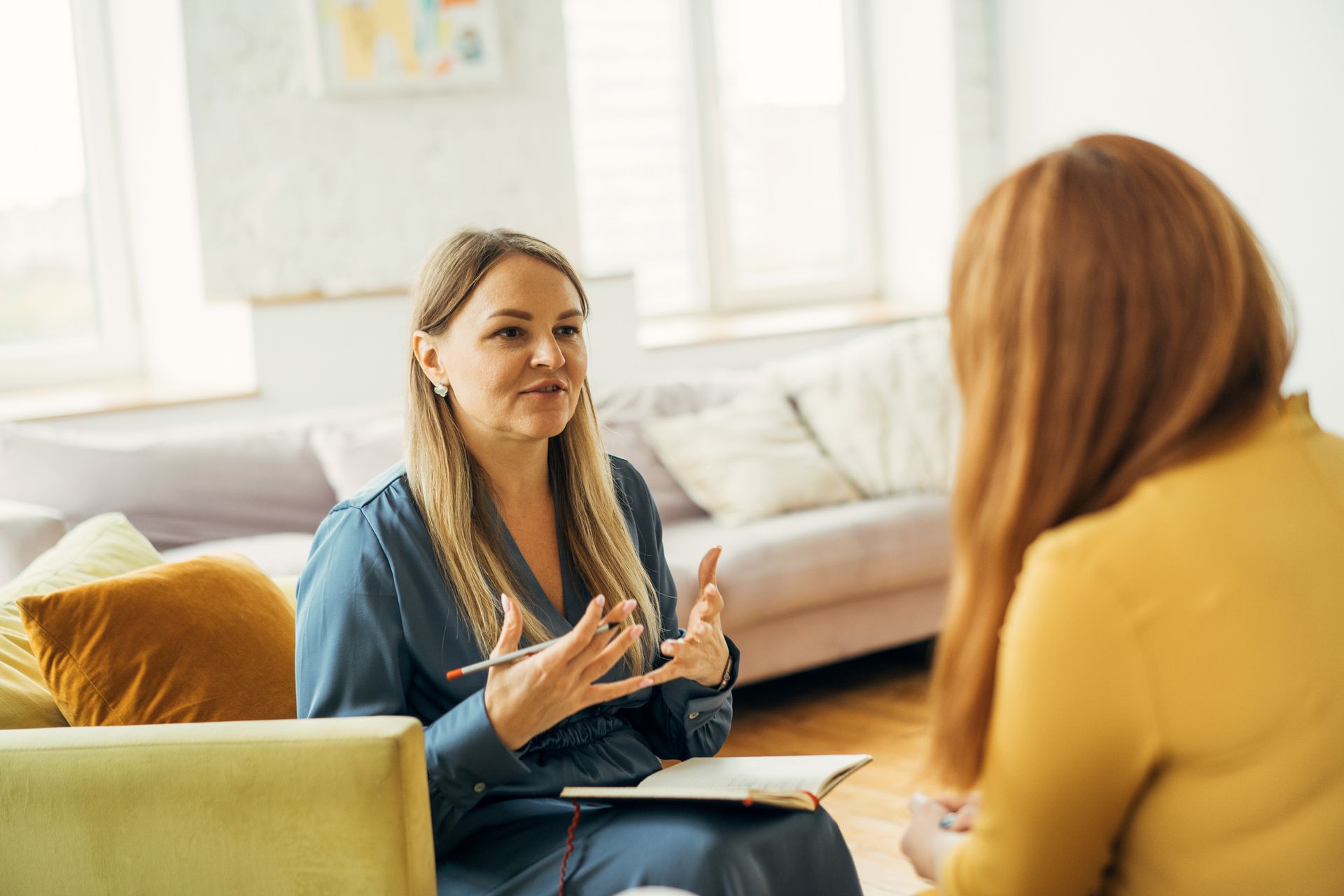 The therapist’s gentle gestures as a woman shares openly in the office.