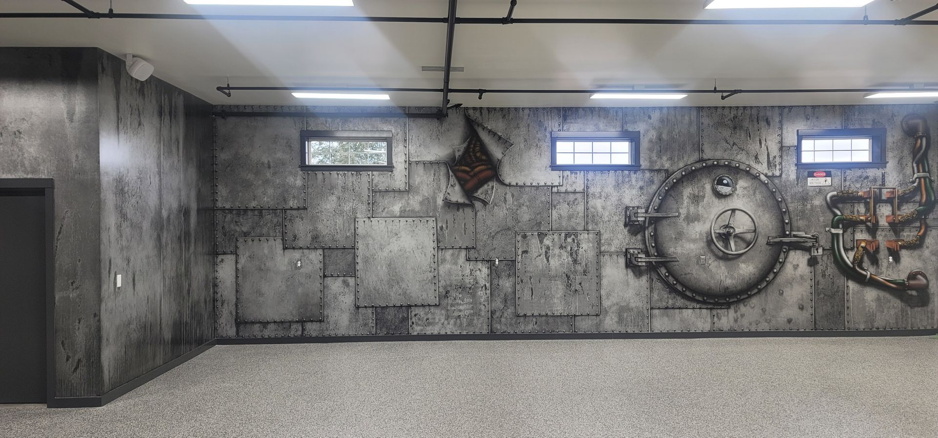 Grimy industrial wall with gauges, pipes, and three glowing windows in a dim concrete corridor