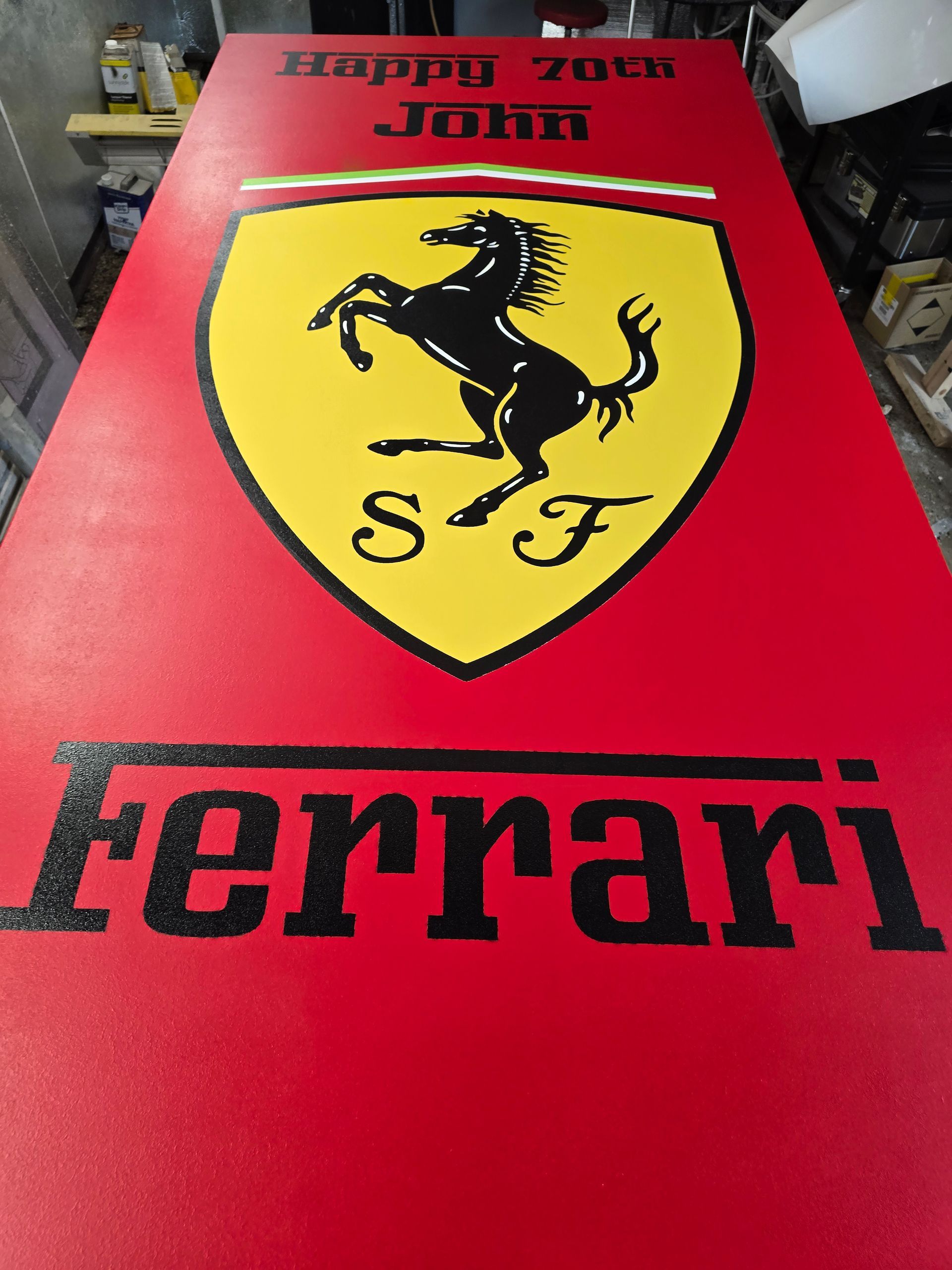 Red Ferrari tabletop with yellow shield logo and black prancing horse, with “Ferrari” text at the bottom.
